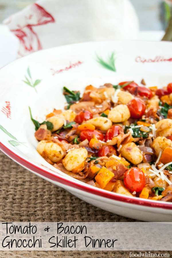 Gnocchi fried in a skillet with cherry tomatoes, bacon, spinach, yellow peppers and pesto. What a great weeknight meal!