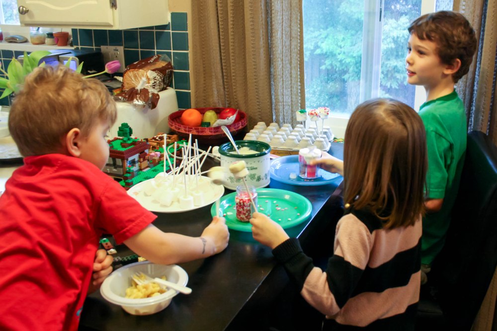 MakingMarshmallow Pops - a great birthday party activity